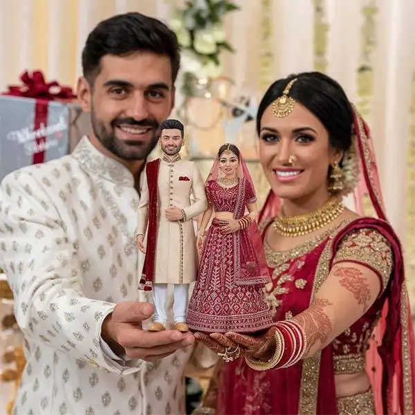 Wedding Couple Holding their Miniature statue received in gift